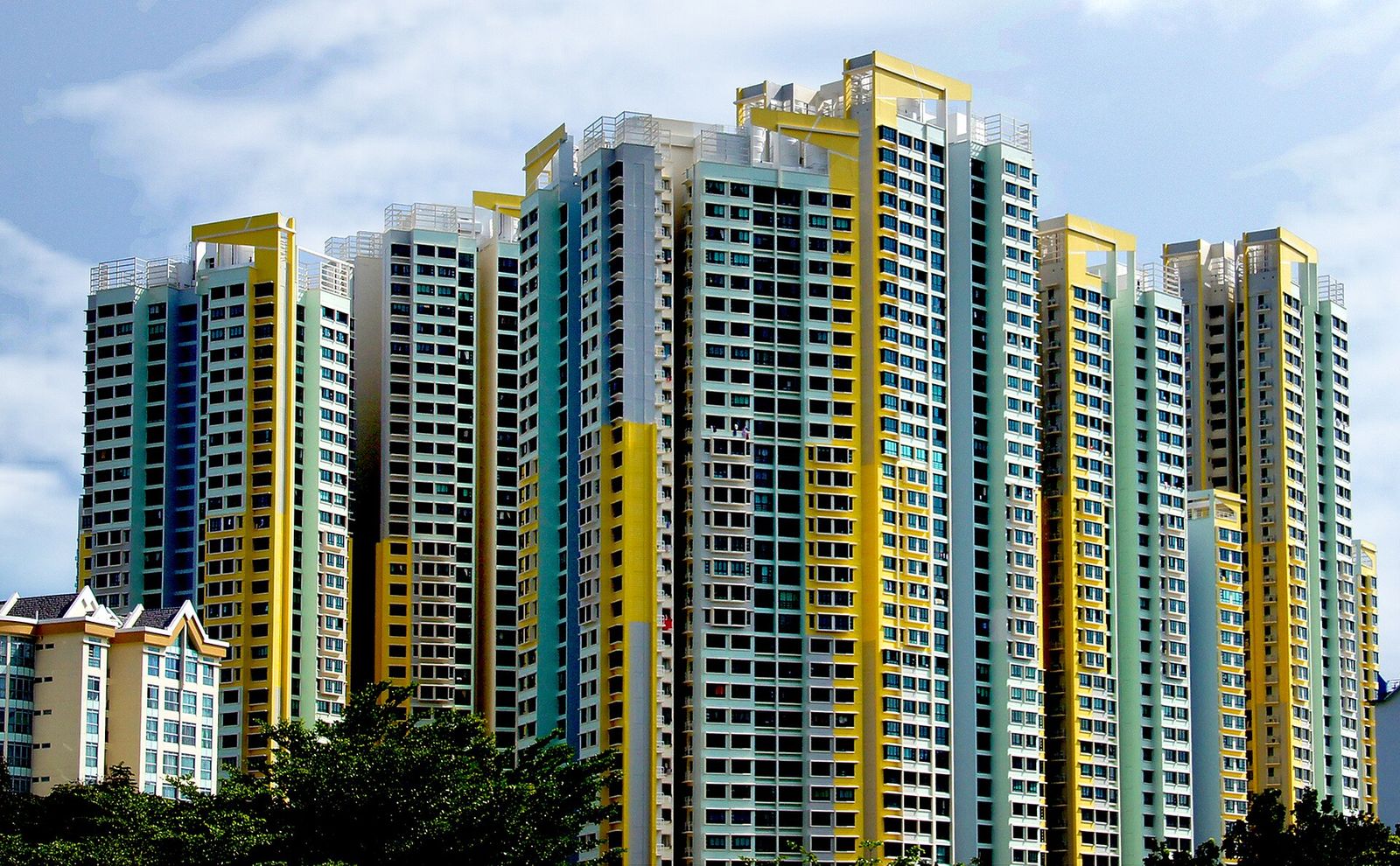 Colourful yellow and blue HDB apartment towers in a Singapore public housing estate